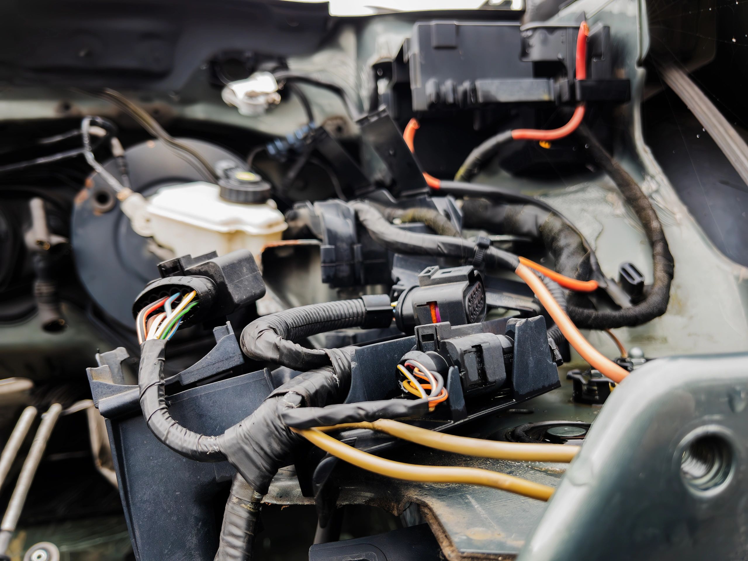 Close-up of car engine wiring and components during diagnostic inspection