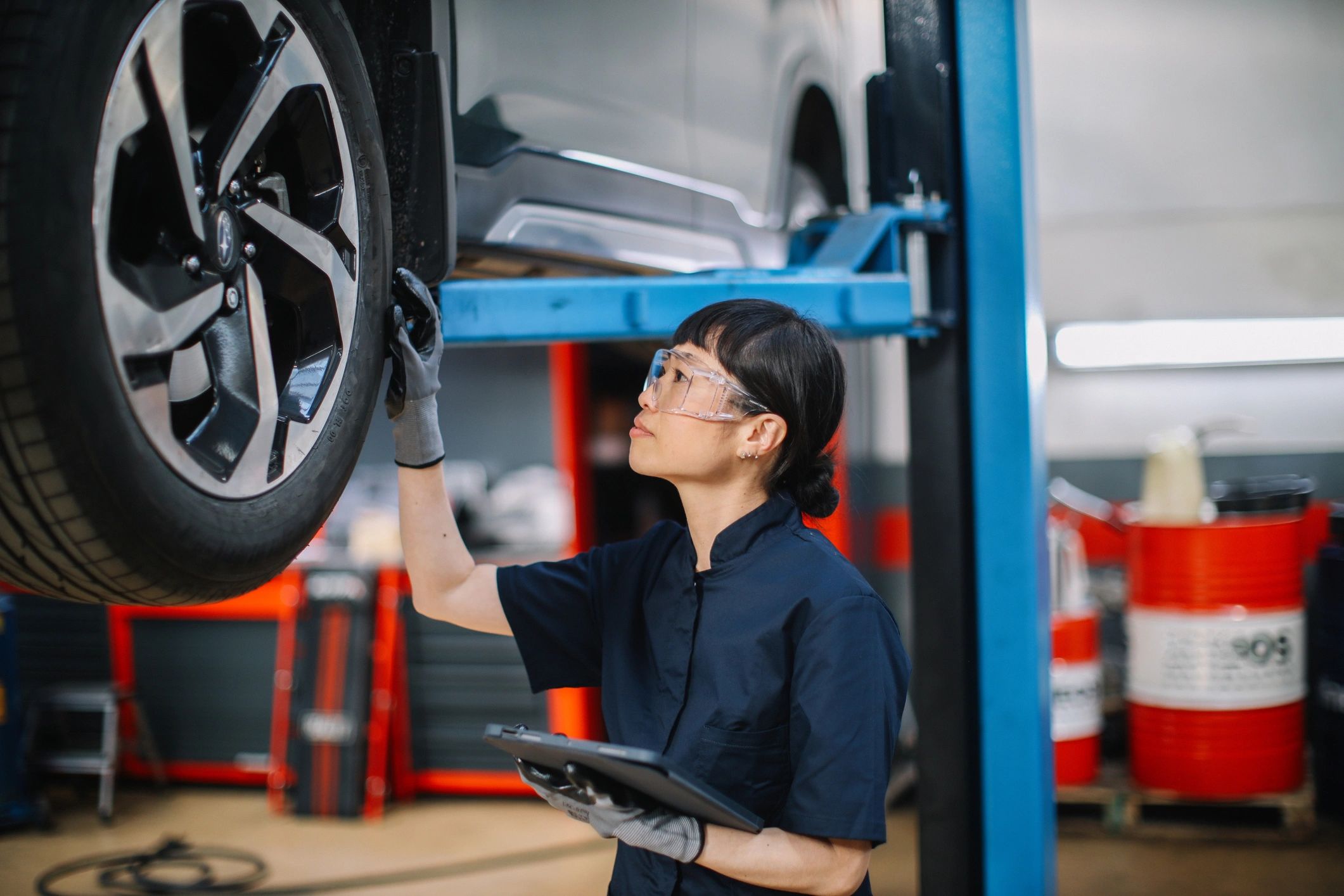 Mechanic using a tablet to review inspection results in the shop