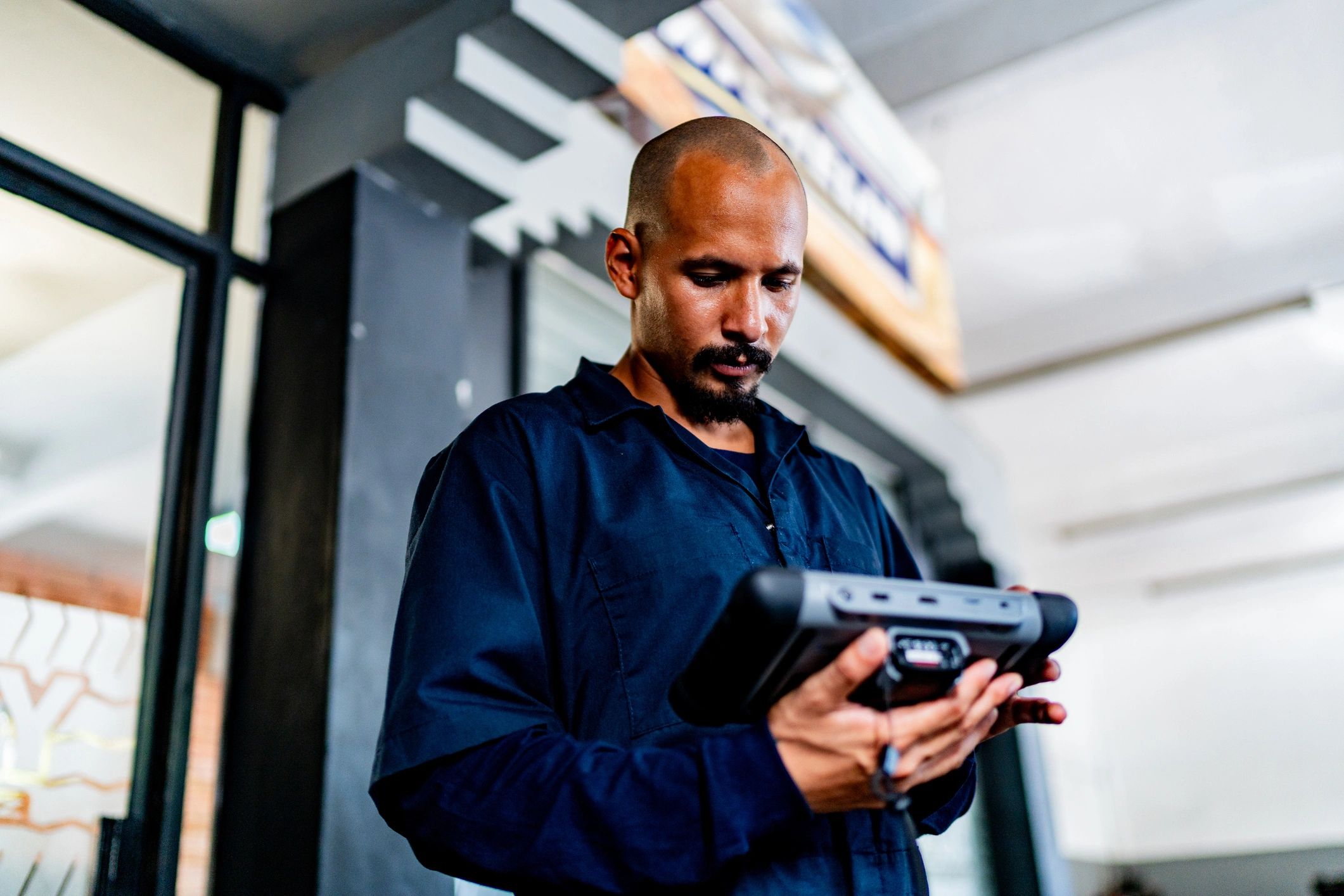 Mechanic using a scan tool to diagnose a vehicle
