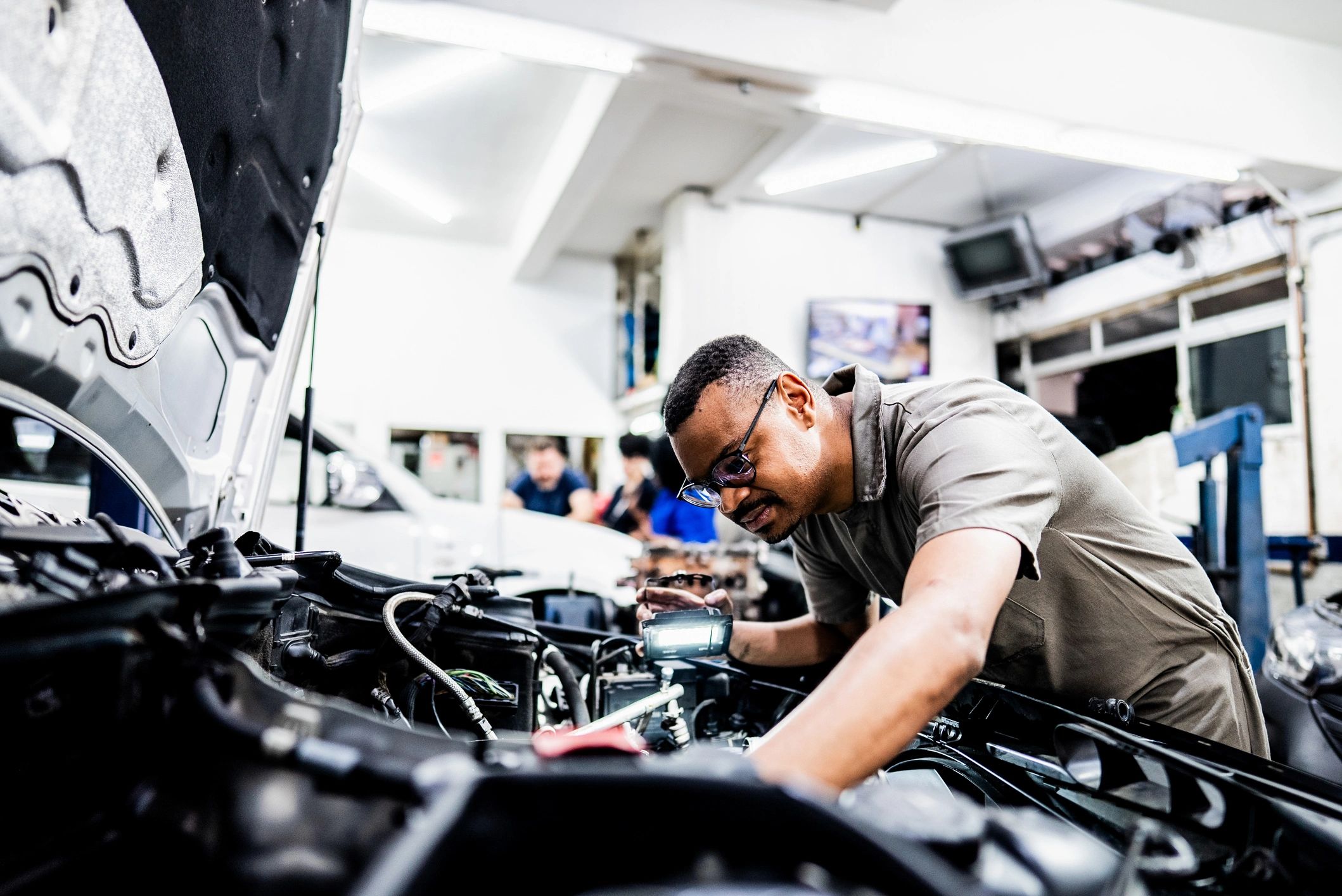 Technician performing ECU tuning in an auto repair shop